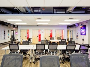 Image of rows of desks with chairs